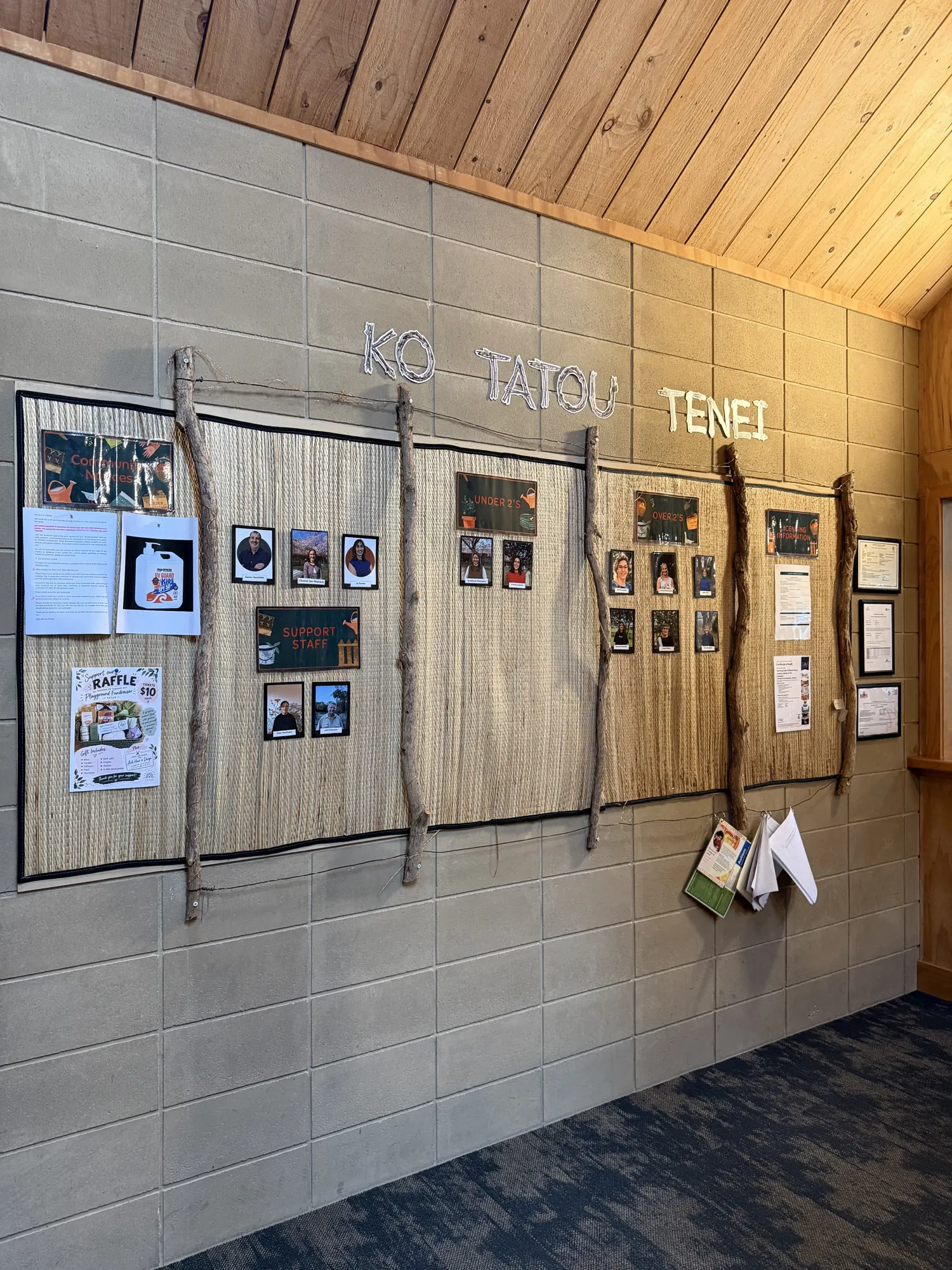 The Ko Tātou Tēnei wall introducing our team, with photos framed by driftwood